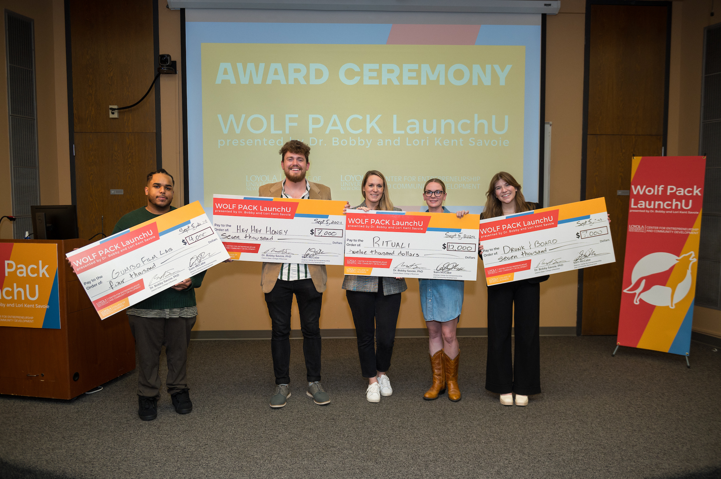 The 2024 Wolf Pack LaunchU winners and their giant checks