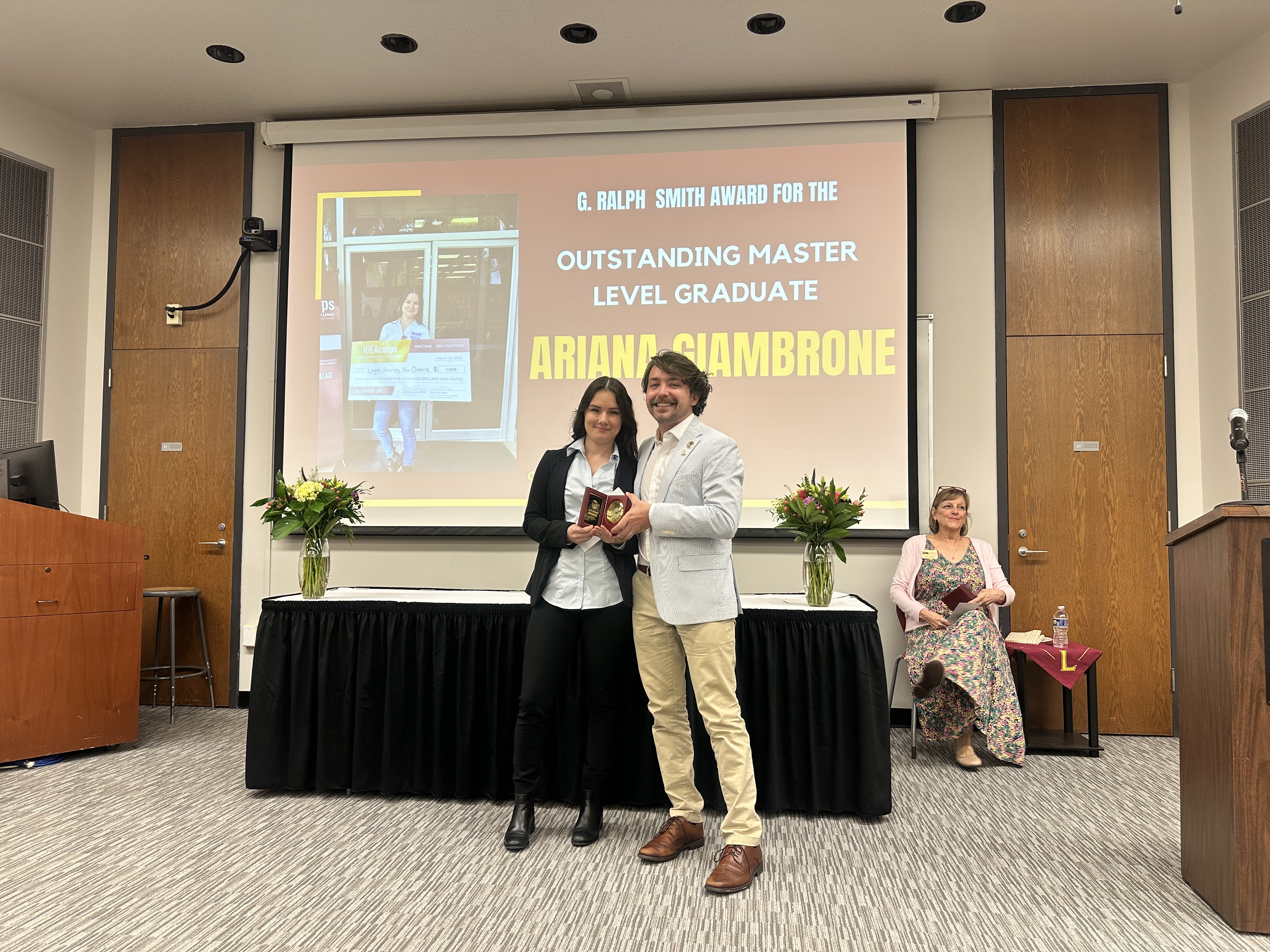 Ariana Giambrone receives the Outstanding Master Level Graduate award from CECD Director Sam McCabe at the 2026 Loyola University New Orleans College of Business Awards Ceremony. Ariana is on the left, Sam is on the right.